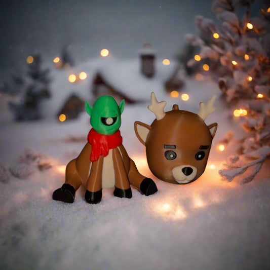 Two toy figures of a reindeer and a character with green hair and red scarf on a white background