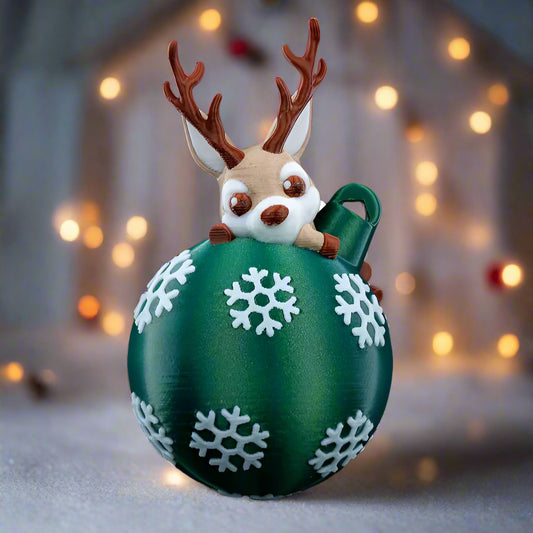 Lying Reindeer Christmas Tree Decoration - Front view with reindeer resting on ornament globe