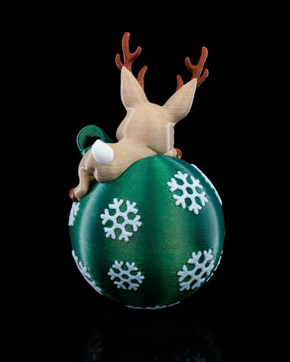 Lying Reindeer ornament featuring playful pose on Christmas globe