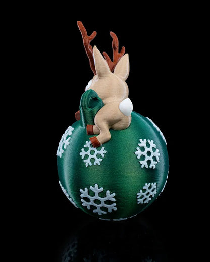 Side view of Lying Reindeer ornament hanging on a Christmas tree