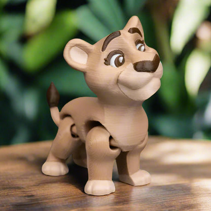 The male and female lion keychains are clipped onto a colorful backpack, swinging gently as if ready to join their owner on an adventure. Their compact size and fun design make them the perfect travel companions for kids or creative adults.