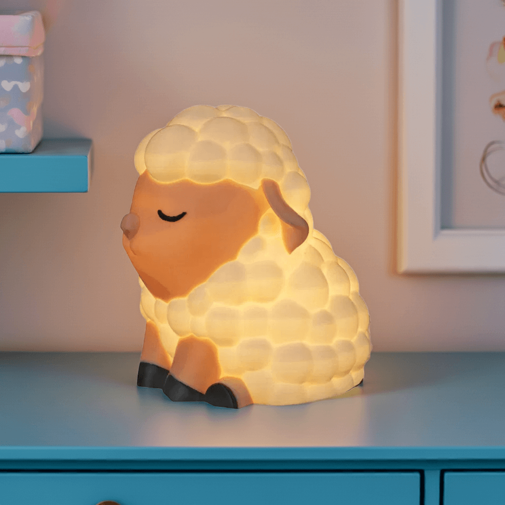 Sheep-shaped night light on a blue surface with a soft background
