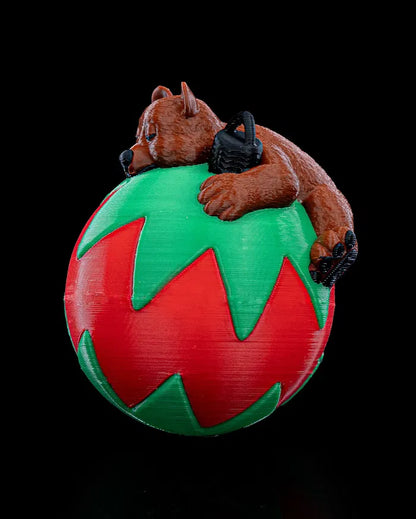 Peaceful sleeping bear inside a globe-shaped Christmas ornament