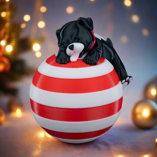 Sleeping Dog Christmas Tree Decoration - Front view with dog resting on globe