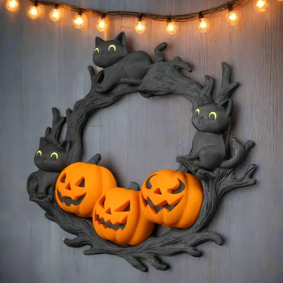 Halloween-themed wreath with black cats and jack-o'-lanterns on a black background