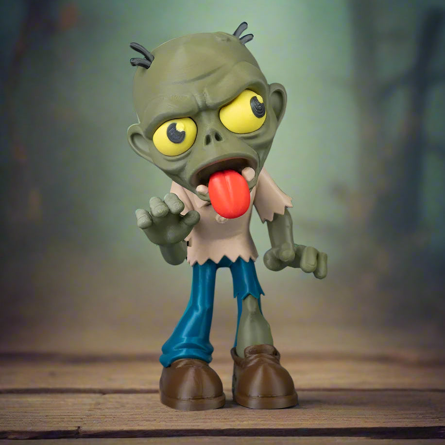 Toy figure of a cartoonish zombie with a red tongue on a wooden surface.