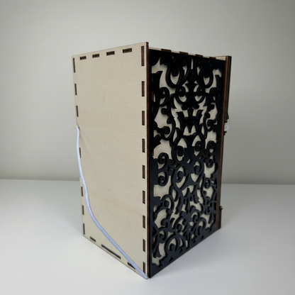 Wooden bookend with decorative black pattern on a white background